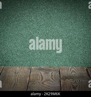 The background is blank wooden boards and a textured plastered wall with lighting and vignetting. Stock Photo