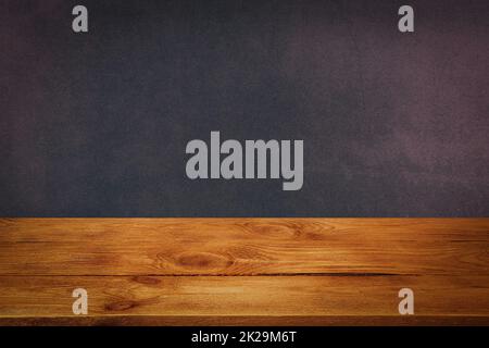 The background is blank wooden boards and a textured plastered wall with lighting and vignetting. Stock Photo