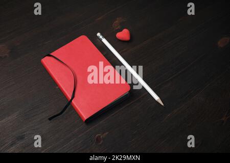 Red notebook, pencil, eraser Stock Photo
