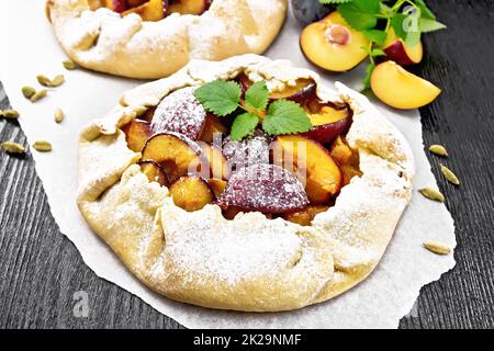 Galeta two with plums on wooden board Stock Photo