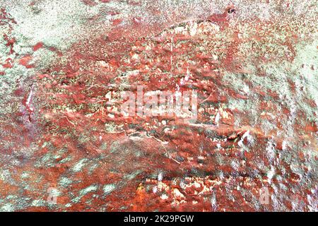 Texture of colorful graffiti paint on conrete and brick walls in red blue purple and silver Stock Photo