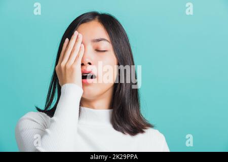 Portrait female bored yawning tired covering mouth with hand Stock Photo