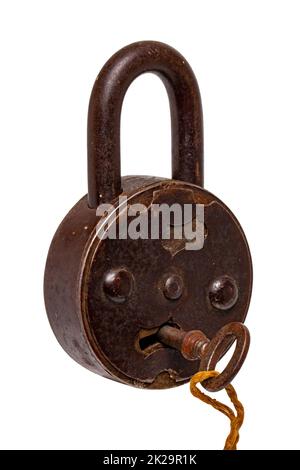 Vintage padlocks isolated. Close-up of a ancient big padlock with key isolated on a white background. Antique objects with clipping path. Macro photograph. Stock Photo