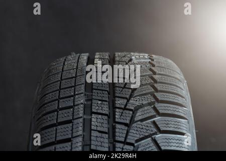 Winter tires with textrued surface in close up with light Stock Photo