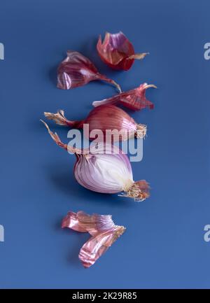 Red tropea onions on a blue background close up Stock Photo