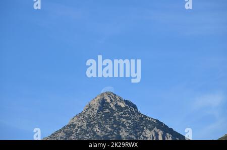 the moon, just before colliding with the mountain, Alicante province, Costa Blanca, Spain Stock Photo