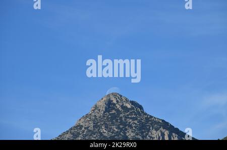 the moon, just before colliding with the mountain, Alicante province, Costa Blanca, Spain Stock Photo