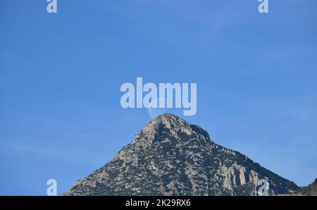 the moon, just before colliding with the mountain, Alicante province, Costa Blanca, Spain Stock Photo