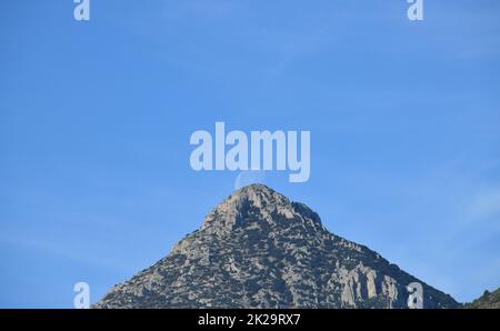 the moon, just before colliding with the mountain, Alicante province, Costa Blanca, Spain Stock Photo