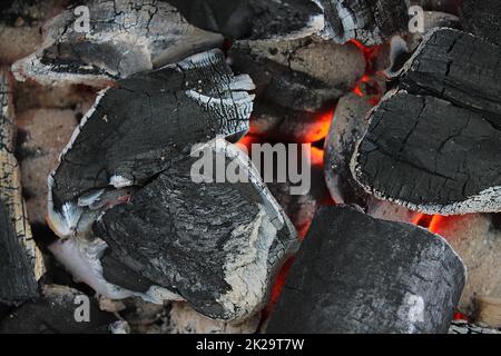 Hot orange burning coal on a barbecue grill. Stock Photo
