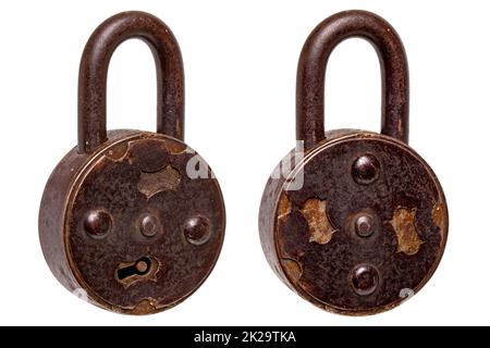 Vintage padlocks isolated. Close-up of an old large padlock with rotating keyhole cover in two views isolated on a white background. Antique objects. Macro. Stock Photo