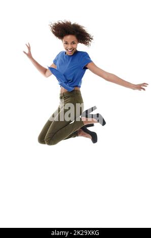 Youthful energy and exuberance. Young african woman jumping with a smile while isolated on white. Stock Photo