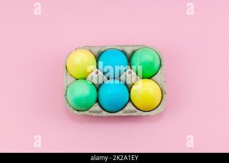 Box with colorful Easter eggs on a pink background Stock Photo