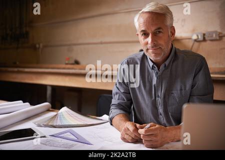 Turning his vision into reality. An architect drawing up plans. Stock Photo