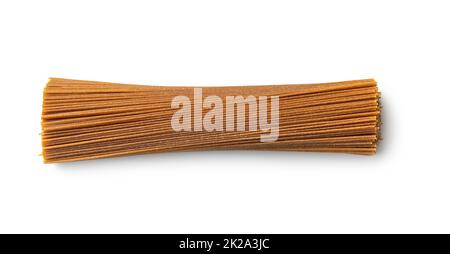 Uncooked whole grain spaghetti. Raw pasta isolated on white background. Stock Photo