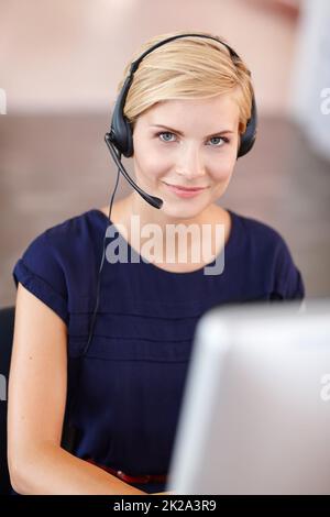 Im here to help. Cropped portrait an attractive young businesswoman working on her computer. Stock Photo