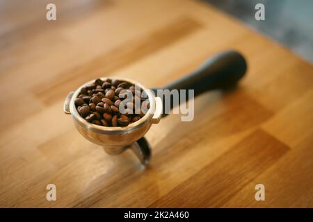 Fresh roasted coffee beans in an espresso filter Stock Photo