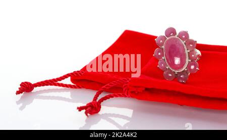 Ruby stones Jewel or gems ring on red velvet bag. Collection of natural gemstones accessories. Studio shot Stock Photo