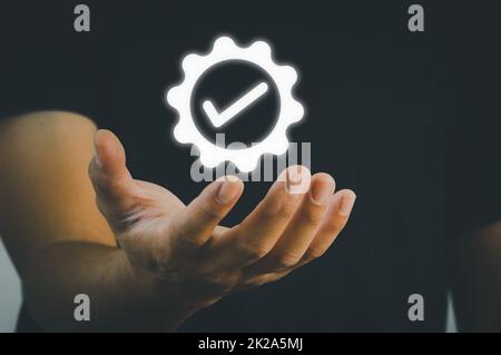 Hand shows the sign of the top service Quality assurance Guarantee, certification and standardization. Copy space business concept. Stock Photo