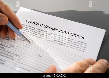 Hand Filling Criminal Background Check Application Stock Photo