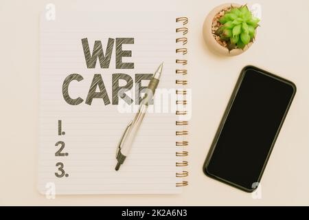 Handwriting text We Care. Business showcase We Care Office Supplies Over Desk With Keyboard And Glasses And Coffee Cup For Working Stock Photo