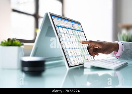 African American Analyst Using Spreadsheet Stock Photo