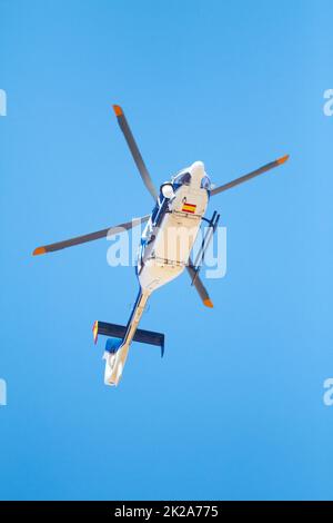 Low angle shot of helicopter flying over train tracks Stock Photo - Alamy