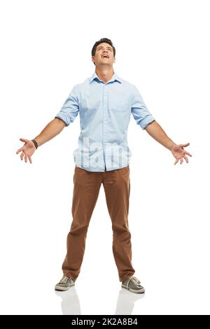 Seriously. A young man looking to the skies with his arms open - isolated. Stock Photo