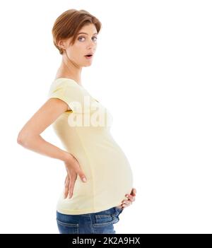 Who knew I could get so big. A young pregnant woman cant believe how big and how fast her belly has grown. Stock Photo