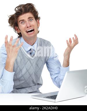 Network problems can drive you insane. A young man freaking out after his laptop lost all of his work. Stock Photo