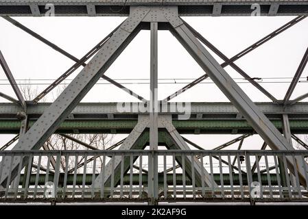 Gray metal train bridge over river. Stock Photo