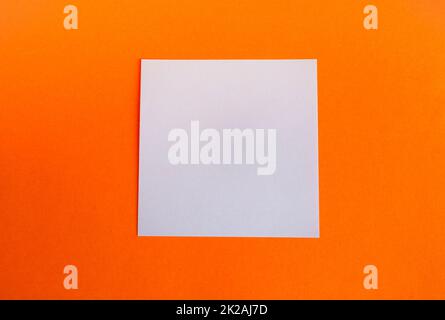 An empty square white composition on a bright orange background.Minimalism style with a copy of the space and a flat frame for Thanksgiving. Abstract fashionable geometric layout blank layout Stock Photo