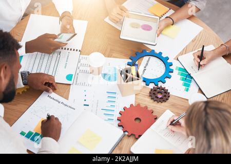 Architects, drawings, engineers and planning in a brainstorming session for a new construction project. Team of young engineers measuring and Stock Photo