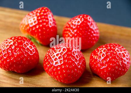Strawberries on a cutting board. Black background Stock Photo