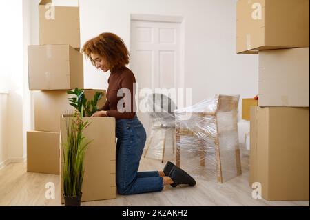 Side view portrait woman signing cardboard box Stock Photo