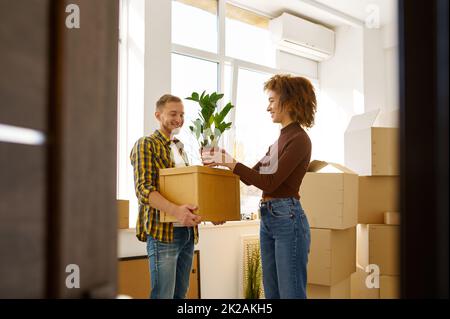 Couple on moving day carrying cardboard boxes Stock Photo