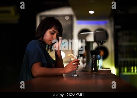 Cant believe I got stood up ... again. A depressed young girl sitting at the bar alone after being stood up. Stock Photo