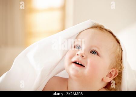 Filled with wonder - Childhood curiousity. Fascinated baby boy looking up at something. Stock Photo