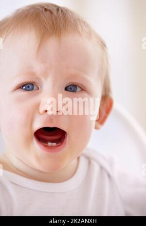 Oh no, wheres she gone now. Closeup shot of a baby boy shouting for a little attention. Stock Photo