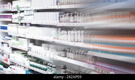Browse our selection of trusted and affordable brands. Shot of shelves stocked with various medicinal products in a pharmacy. Stock Photo