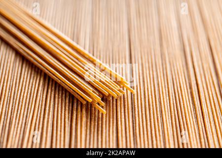 Uncooked whole grain spaghetti. Raw pasta Stock Photo