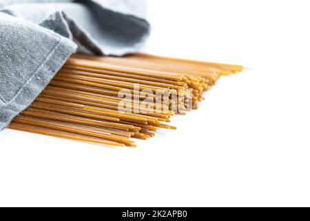 Uncooked whole grain spaghetti. Raw pasta isolated on white background. Stock Photo