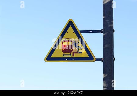 Warning sign at a train station. Attention danger with passing trains Stock Photo