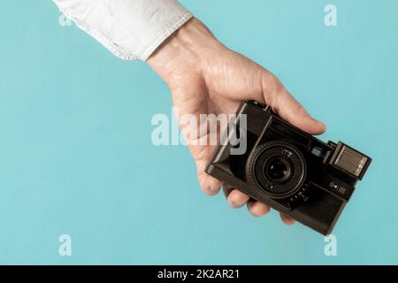 Hand holding old film photo camera Stock Photo