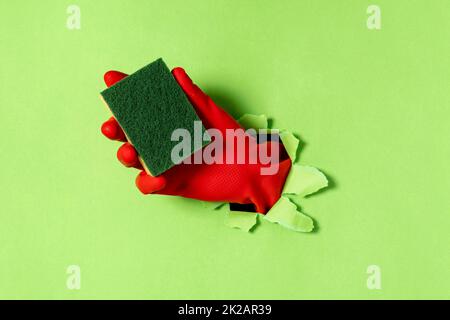A hand in a rubber glove with dishwashing sponge Stock Photo