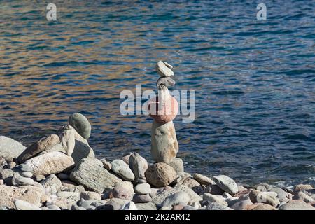 Stacks of Zen stones on the coast. Stock Photo