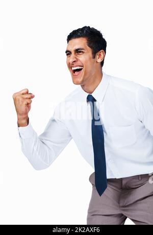 Victorious young business man. Portrait of happy young business man celebrating victory on white background. Stock Photo