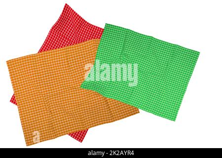 Closeup of a green, brown, red white checkered napkin or tablecloth texture isolated on a white background. Kitchen accessories. Top view. Stock Photo