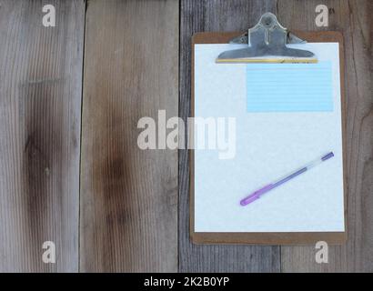 Clipboard With Blank Sheet of Paper on Wooden Table Stock Photo