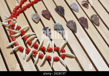 Native American Arrowheads and Beaded Necklace With Coyote Teeth Stock Photo